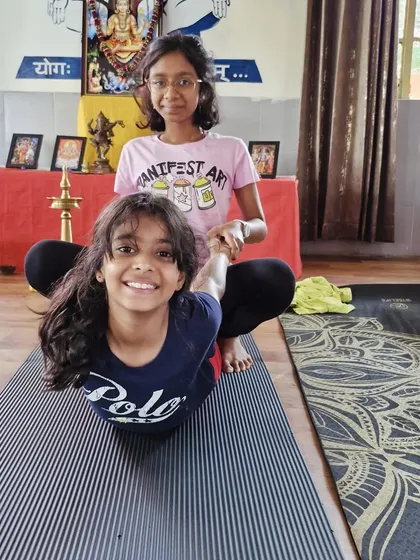Introducing yoga to children is a joyful experience. In our kids and parents retreats, we use playful partner poses, like this assisted bow pose, to build strength, trust, and a lifelong love for wellness.