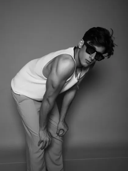 A stylish and moody black and white pose, perfect for a men's fashion editorial.