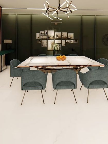 In this open-plan home, the dining area is defined by a dark green accent wall and a large, rustic dining table. The space is designed to feel connected to the living area, perfect for large gatherings.