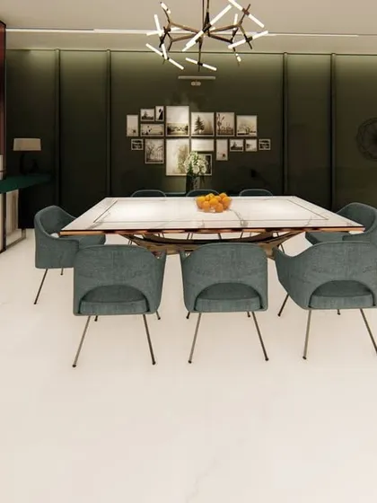 In this open-plan home, the dining area is defined by a dark green accent wall and a large, rustic dining table. The space is designed to feel connected to the living area, perfect for large gatherings.