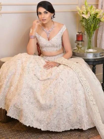 A vision in white. A bride exudes elegance and charm in a stunning white lehenga, her look completed with my ruby and diamond bridal necklace set.