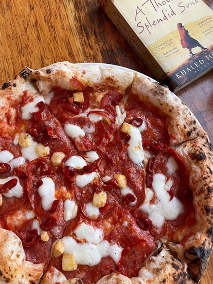 Pizza love, baked fresh. A spicy pepperoni pizza and a good book make for a great evening.