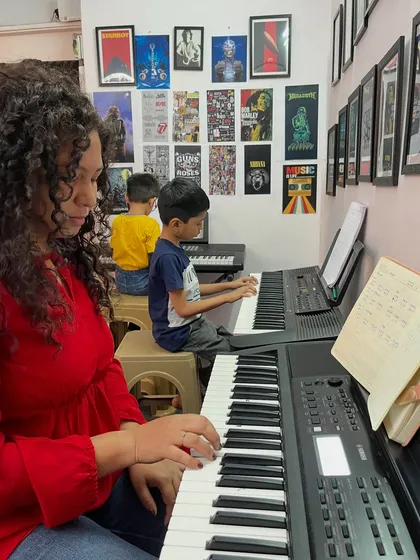 An ongoing keyboard session at our studio. You can see students of different ages focused on their practice, with an instructor nearby to provide guidance.
