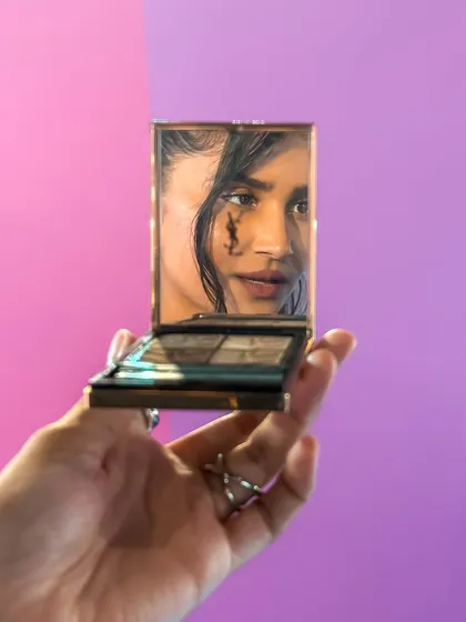A creative shot using a compact mirror to reflect my makeup at the YSL Beauty Light Club Party.