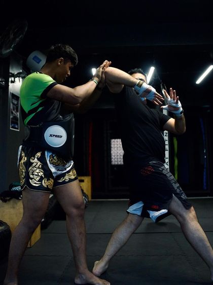A close-up of a hand-trapping drill, where fighters learn to control their opponent's arms.