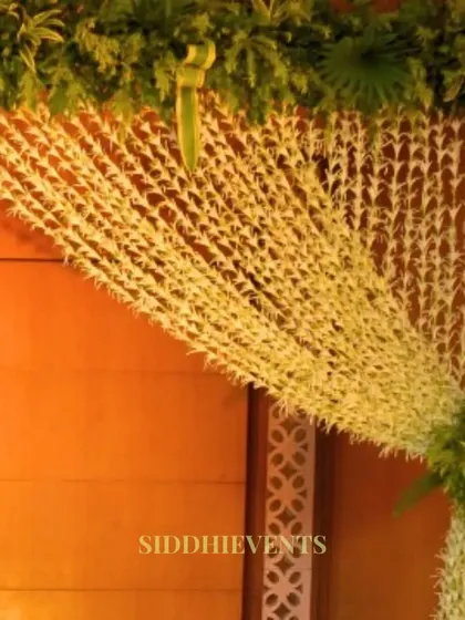 An enchanting entrance decoration made from a curtain of delicate white tuberose strings, creating a fragrant and beautiful natural screen.