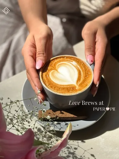 It’s more than just coffee, it’s a little piece of art. Our baristas take pride in every cup, like this perfectly poured latte with heart art, served with a side of flowers and good vibes.