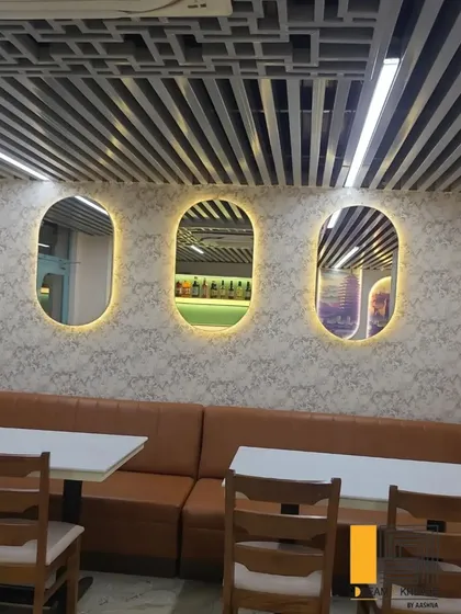 This seating area features back-lit oval mirrors that add a soft glow and a sense of spaciousness to the room.