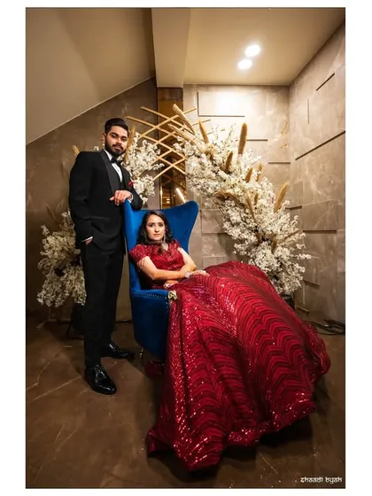 A regal portrait for a reception or cocktail event. The bride's stunning red gown is the star of the show.