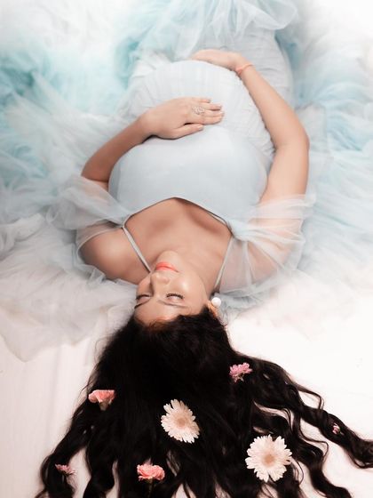 A creative overhead shot showing the beautiful spread of our Winter gown. The ombre blue tulle looks like gentle waves, perfect for artistic and serene maternity portraits.