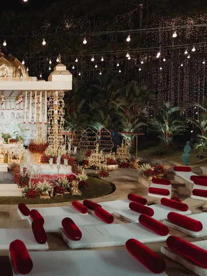 Another perspective of the grand mandap and amphitheater seating under the stars. The combination of architectural lighting on the mandap and ambient string lights creates a warm and inviting environment.