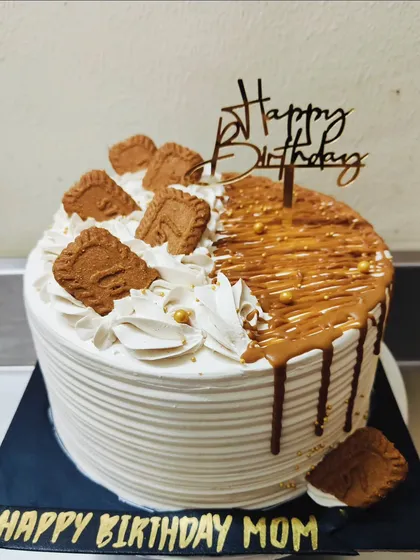 A delicious Caramel and Biscoff flavored cake for a special mom. The combination of drip and biscuits on top makes it look as good as it tastes.