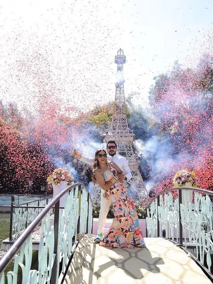 A larger-than-life celebration moment from the 'AmanFoundHisRhythm' wedding, where we used confetti and color smoke cannons to create a spectacular visual for the couple's entry.