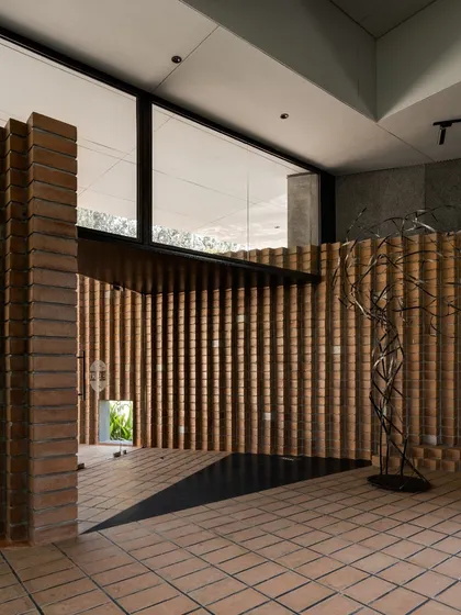 Craftsmanship and material honesty are central to our work. In 'The Earth' project, these pleated walls are made from locally sourced Compressed Stabilised Earth Blocks (CSEB), creating a rich texture that plays with light and shadow throughout the day.