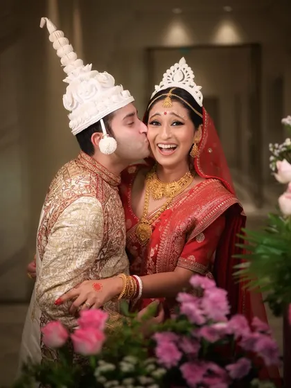 The vibrant colors and infectious happiness of a traditional Bengali wedding. I love capturing the unique cultural rituals and candid joy of all types of ceremonies. This photo is full of life, from the couple's expressions to the beautiful floral details.