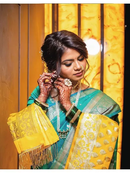 Gold glitter eyes and a flawless, unedited base for Ashlesha's wedding. This look balances traditional elements with a touch of modern glam.
