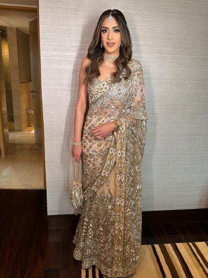 The full view of the intricately embroidered saree. The hair and makeup complete this look of pure sophistication.