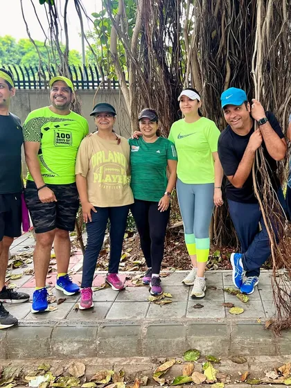 The group posing under a banyan tree during a birthday run. We find beautiful spots to celebrate and take photos.