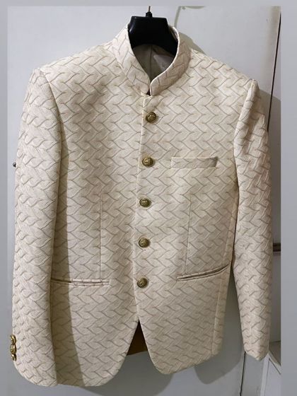 A finished off-white Jodhpuri jacket with a basket-weave texture, ready for delivery. The craftsmanship is in the clean lines and perfect structure.