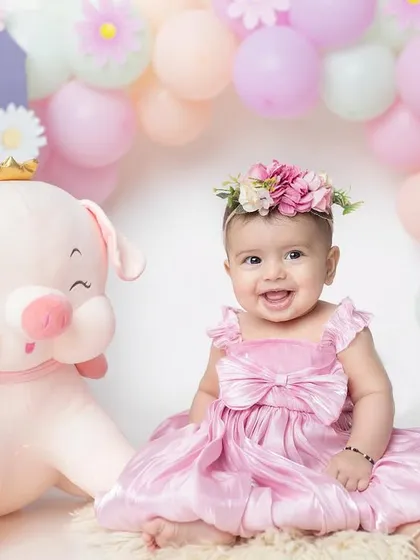 Celebrating six sweet months with a lovely pastel and floral theme. This little princess is sitting pretty with her giant piggy friend.