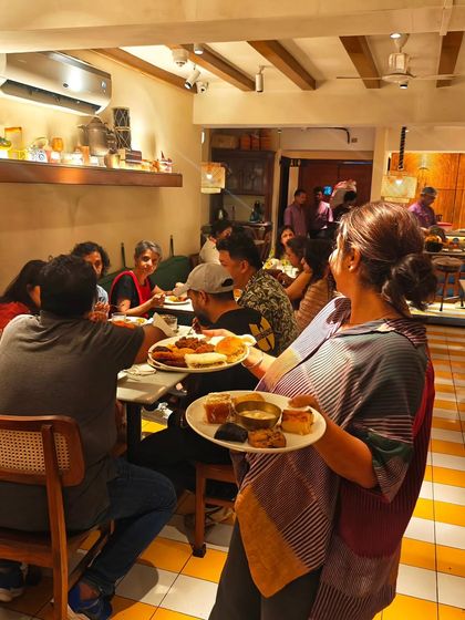 Another shot from our home chef collaboration, with plates full of diverse Indian snacks being served to eager guests. The energy in the room was just incredible.
