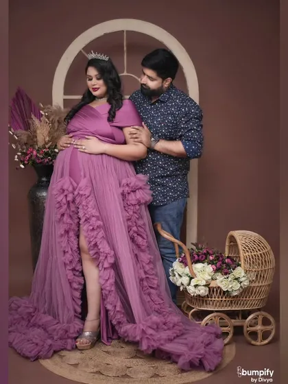 A sweet and protective pose from the dad-to-be, with his arm around his partner as they stand by the baby pram. A perfect family-in-the-making portrait.