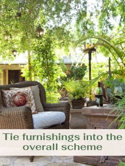 The key to a well-designed outdoor space is integrating furniture with the natural surroundings. This wicker armchair, with its plush cushions, is placed to offer a comfortable viewpoint of the garden, showing how the right furnishings can complete the overall scheme.
