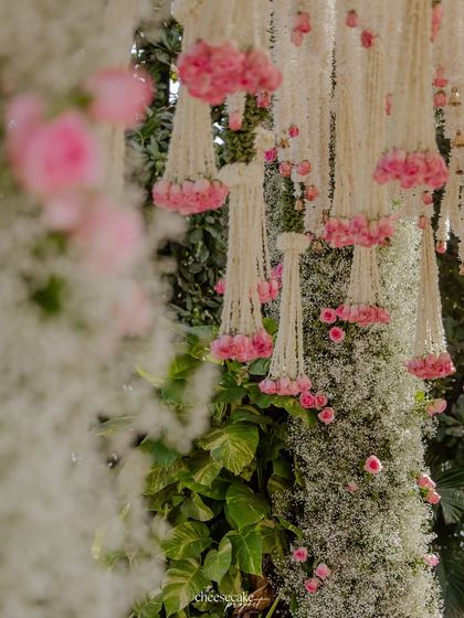 A detailed shot of the delicate floral hangings, combining baby's breath, tuberose, and pink roses.
