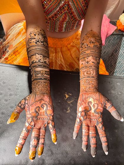 The stain on this design with swan and elephant motifs is deep and rich, highlighting the intricate details.