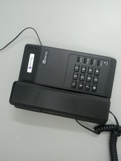 A close-up of a Beetel telephone handset, a reliable choice for office intercom systems that we frequently install.