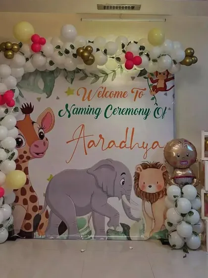 A naming ceremony is such a special day. For this event, I created a custom jungle-themed backdrop with cartoon animals and a beautiful balloon arch to welcome baby Aaradhya.