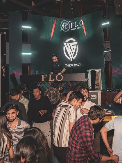 A wide view of the party at Flo, with my logo on the screen, showing the full setup.