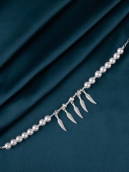 A pearl bracelet with multiple dangling silver feather charms.