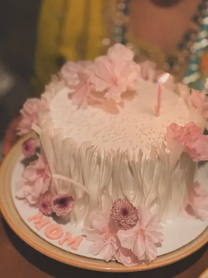 An artistic cake for Mom with a unique white fringe texture and delicate pink wafer paper flowers.