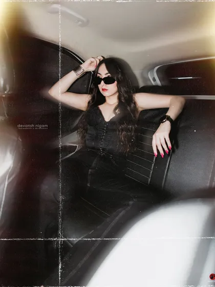 A classic cool pose in the backseat, exuding confidence and style.
