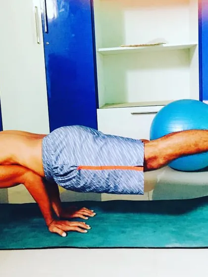 Peak performance requires a strong foundation. Here, I am demonstrating an advanced core stability and balance exercise using a yoga mat and stability ball, a key part of our sport-specific fitness training to build functional strength for tennis.