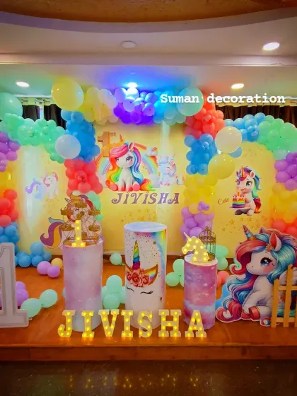 A slightly different angle of the unicorn party, showing how the lighting enhances the vibrant colors of the balloons and the backdrop.