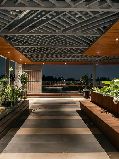 The terrace at our Hennur residence is designed as a seamless extension of the indoors. We used a metal pergola, warm wooden accents, and lush greenery around a tranquil koi pond to create a perfect open-to-sky retreat for relaxed evenings and lively gatherings.