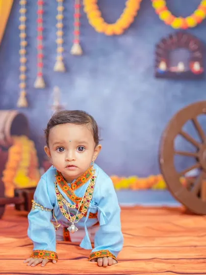 **Hero Item:** I offer creative, themed baby photoshoots like this Krishna-inspired session. This setup in my Bangalore studio includes custom backdrops, traditional props, and costumes to create truly memorable milestone portraits for your child.