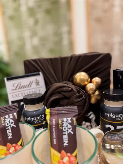 A detail shot of the fitness-themed items, including Max Protein bars and Epigamia Turbo shots, alongside a touch of indulgence with Lindt chocolate.