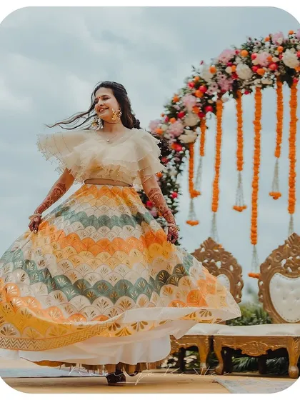 A vision of pure joy and movement. This custom lehenga, with its vibrant chevron pattern in hues of yellow, orange, and teal, is designed for celebration. The lightweight fabric and full flare make it perfect for a lively sangeet or mehendi ceremony.