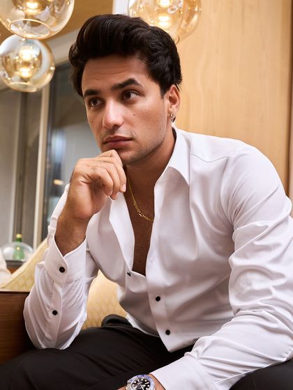Cricketer Abhishek Sharma in a custom Zafir and Shadab look. The open white shirt paired with black trousers is a classic combination that’s both sharp and effortlessly cool.