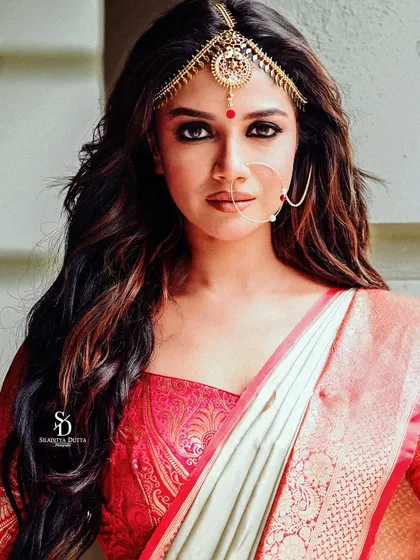 A close-up beauty shot of Sauraseni from the Calcutta Times Pujo shoot. The focus is on her striking makeup, the traditional 'matha patti' on her forehead, and her intense gaze.