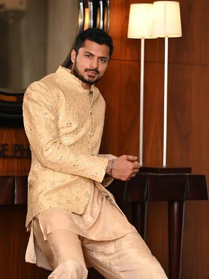 Leaning in with a confident smile, this shot adds a personal and engaging touch to the ethnic wear photoshoot.