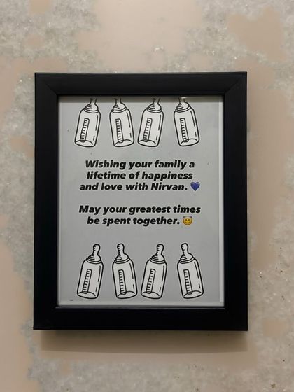 A sweet frame created for a baby shower. This custom piece includes a personal message for the family and the baby's name, making it a cherished keepsake.