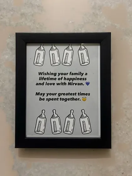 A sweet frame created for a baby shower. This custom piece includes a personal message for the family and the baby's name, making it a cherished keepsake.
