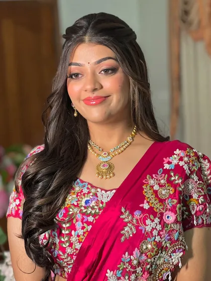 The client looking stunning with her floral half-updo and matching embroidered lehenga.