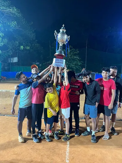 The ultimate moment of victory in our Tennis Temple Premier League. A team celebrates hoisting the championship trophy under the floodlights, capturing the spirit of competition and teamwork that defines our league.