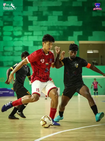 A player battling for the ball against an opponent.