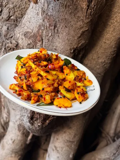 A creative shot of our Jackfruit Seed Stir-fry, highlighting its connection to nature. This dish is a celebration of using the whole fruit and finding flavour in unexpected places.